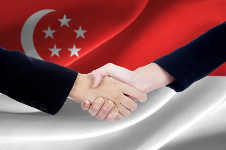 depositphotos_89323052-stock-photo-handshake-with-flag-of-singapore_cleanup